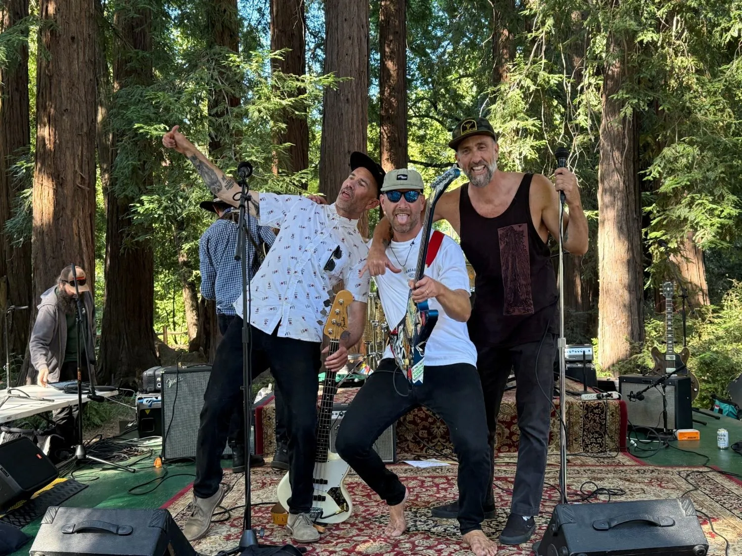 Torpedo Wharf mugging on the rug-covered stage under the redwoods at Peri Park
